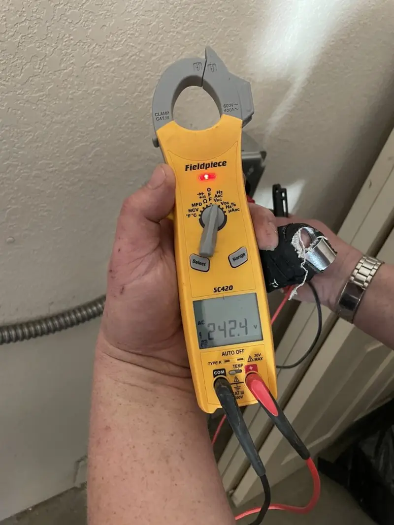 Voltage testing with clamp meter during Ceiling Fan Installation in Mandan